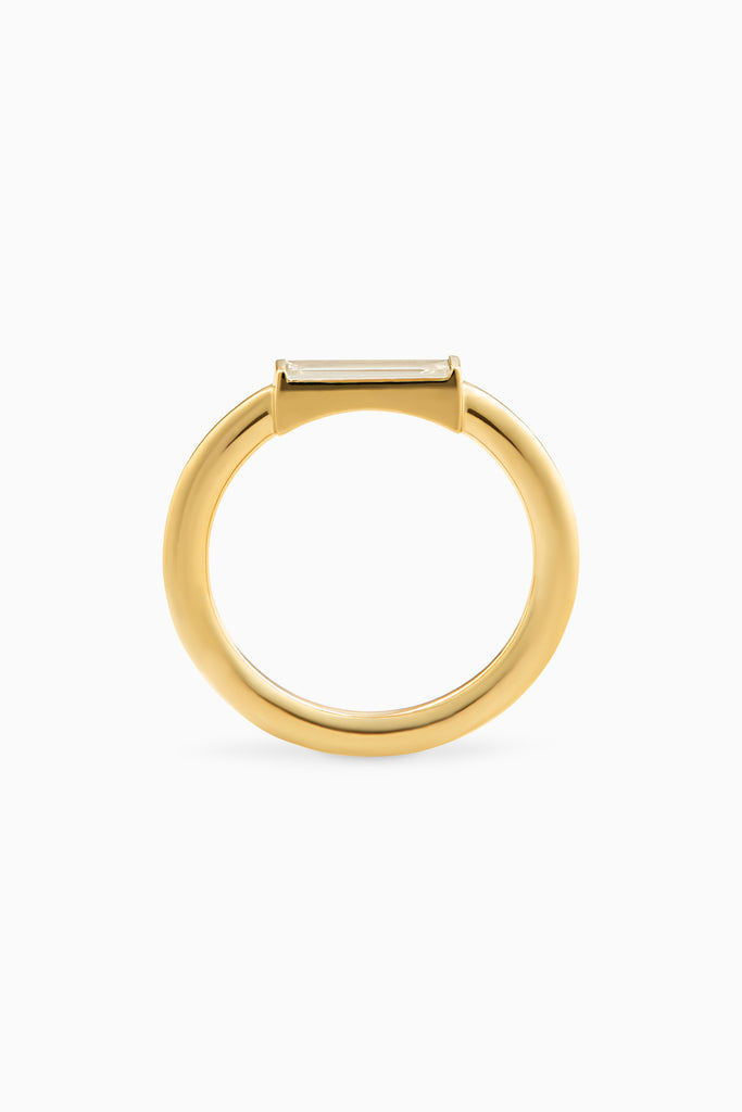 A yellow gold mini baguette ring with a baguette cut diamond set in a simple setting.